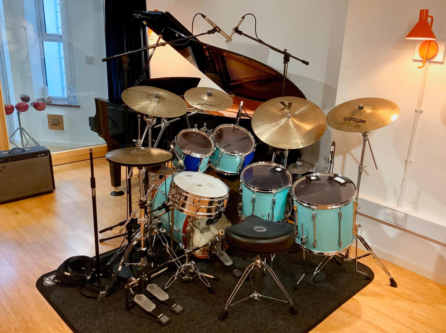 Drum kit and grand piano in recording studio